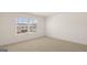 Spacious bedroom featuring neutral carpet, bright window, and ample natural light at 1628 Palladian Dr, Lithonia, GA 30058