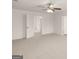 A view of a carpeted bedroom with white walls and ceiling fan at 1628 Palladian Dr, Lithonia, GA 30058