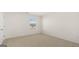 A spacious, carpeted bedroom with a bright window and minimal design at 1628 Palladian Dr, Lithonia, GA 30058