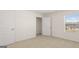 Neutral carpeted bedroom with a closet and window providing natural light at 1628 Palladian Dr, Lithonia, GA 30058