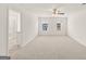Spacious bedroom with two windows, carpet flooring, and a ceiling fan at 1628 Palladian Dr, Lithonia, GA 30058