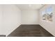 A clean, bright bedroom has wood-look floors and a window for natural light at 1628 Palladian Dr, Lithonia, GA 30058