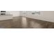 Open dining area with wood-look flooring, a large window and access to the kitchen at 1628 Palladian Dr, Lithonia, GA 30058