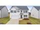 Charming two-story home featuring white siding, dark shutters, and a well-manicured lawn at 1628 Palladian Dr, Lithonia, GA 30058