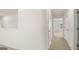 Hallway featuring modern doors, neutral carpet, and bright, open floorplan at 1628 Palladian Dr, Lithonia, GA 30058