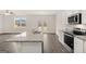 Bright kitchen featuring granite countertops, stainless steel appliances, and center island with sink at 1628 Palladian Dr, Lithonia, GA 30058