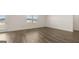 Bright open living room with wood-look flooring, neutral walls, and a door to the outside at 1628 Palladian Dr, Lithonia, GA 30058