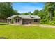 Back exterior view of home with a grill and large yard at 3775 Highway 16 E, Sharpsburg, GA 30277