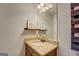 Bathroom vanity with decorative countertop and large, well-lit mirror at 312 Relative Trl, Mcdonough, GA 30253
