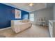 Spacious bedroom features a blue accent wall, carpet, and a built-in bed at 312 Relative Trl, Mcdonough, GA 30253