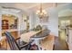 Open dining room with wainscotting, hardwood floors, and a chandelier at 312 Relative Trl, Mcdonough, GA 30253