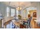 Cozy dining area with a table, bench seating, chandelier, and many bright windows at 312 Relative Trl, Mcdonough, GA 30253