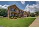 Beautiful brick home exterior featuring a well-maintained lawn, shrubs, and ample driveway space at 312 Relative Trl, Mcdonough, GA 30253