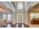 Grand two-story foyer with hardwood floors, arched entryways, and abundant natural light at 312 Relative Trl, Mcdonough, GA 30253