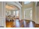 Elegant foyer showcasing hardwood floors, white trim, and an open dining area at 312 Relative Trl, Mcdonough, GA 30253