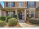 Inviting front entrance with a black door, decorative wreath, and manicured landscaping at 312 Relative Trl, Mcdonough, GA 30253