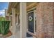 Charming front porch with seating, a decorative wreath on the door, and brick accents at 312 Relative Trl, Mcdonough, GA 30253