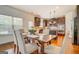 Open floor plan with the kitchen adjacent to a dining area with a farmhouse style table at 312 Relative Trl, Mcdonough, GA 30253