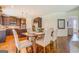 Open floor plan with the kitchen adjacent to a dining area with a farmhouse style table at 312 Relative Trl, Mcdonough, GA 30253