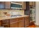 Close-up of stainless appliances, granite counters, and modern cabinetry in the kitchen at 312 Relative Trl, Mcdonough, GA 30253