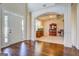 Elegant living space with hardwood floors, archways, coffered ceiling, and natural light at 312 Relative Trl, Mcdonough, GA 30253