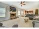 Open-concept living room features a fireplace and flows into the adjacent kitchen at 312 Relative Trl, Mcdonough, GA 30253
