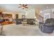 Spacious living room is complete with plush carpet, large windows, and neutral tones at 312 Relative Trl, Mcdonough, GA 30253