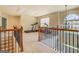 Loft area with exercise equipment and wrought iron banister overlooking lower level at 312 Relative Trl, Mcdonough, GA 30253