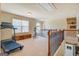 Loft area with exercise equipment and wrought iron banister overlooking lower level at 312 Relative Trl, Mcdonough, GA 30253