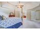 Spacious main bedroom featuring a tray ceiling, carpeted floors and a doorway to an adjacent room at 312 Relative Trl, Mcdonough, GA 30253