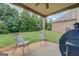 Covered patio area featuring two chairs and a beautiful view of the backyard at 312 Relative Trl, Mcdonough, GA 30253