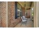 Comfortable front porch area with chairs overlooking the landscaped front yard at 312 Relative Trl, Mcdonough, GA 30253