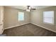 Cozy bedroom with neutral walls, two windows, and a ceiling fan at 2015 Boulderview Se Dr, Atlanta, GA 30316