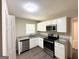 Well-lit kitchen with stainless steel appliances, granite countertops, and white cabinets at 2015 Boulderview Se Dr, Atlanta, GA 30316