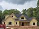 Charming new home featuring a craftsman-style exterior with yellow siding and black windows at 365 Spruill Bridge Road # 7 - Helmsley Park, Temple, GA 30179
