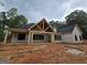Exterior elevation of a new home with a covered back porch and black framed windows at 365 Spruill Bridge Road # 7 - Helmsley Park, Temple, GA 30179