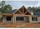 New construction showcases a covered back patio, featuring an open ceiling and several windows at 365 Spruill Bridge Road # 7 - Helmsley Park, Temple, GA 30179