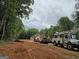 Exterior of a new home in a wooded setting with heavy equipment at 365 Spruill Bridge Road # 7 - Helmsley Park, Temple, GA 30179