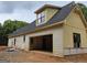 Side exterior of home showing a new construction with an attached, open two-car garage at 365 Spruill Bridge Road # 7 - Helmsley Park, Temple, GA 30179