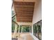 Side view of the back porch features a wood ceiling, pillars, and multiple black windows at 365 Spruill Bridge Road # 7 - Helmsley Park, Temple, GA 30179