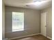 Bedroom features neutral walls, carpet flooring, a window, and a white door at 755 Kilkenny Cir, Lithonia, GA 30058