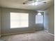 Spacious bedroom with two windows letting in natural light and a ceiling fan at 755 Kilkenny Cir, Lithonia, GA 30058