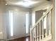 Bright entryway featuring hardwood floors, white trim and staircase, and a white front door with sidelights at 755 Kilkenny Cir, Lithonia, GA 30058