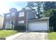 Brick and gray siding two-story home with an attached garage and a concrete driveway at 755 Kilkenny Cir, Lithonia, GA 30058