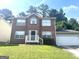 Charming brick two-story home with an attached garage and a well-maintained lawn at 755 Kilkenny Cir, Lithonia, GA 30058