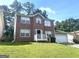 Charming brick two-story home with an attached garage and a well-maintained lawn at 755 Kilkenny Cir, Lithonia, GA 30058