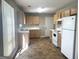 Functional kitchen featuring wood cabinets, tile floors, and white appliances at 755 Kilkenny Cir, Lithonia, GA 30058