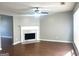 Living room with wood floors, neutral walls, white trim, a fireplace and ceiling fan at 755 Kilkenny Cir, Lithonia, GA 30058