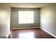 Living room with wood floors, neutral walls, white trim and a large window at 755 Kilkenny Cir, Lithonia, GA 30058