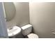 Simple powder room featuring gray walls, a pedestal sink and a round mirror at 755 Kilkenny Cir, Lithonia, GA 30058